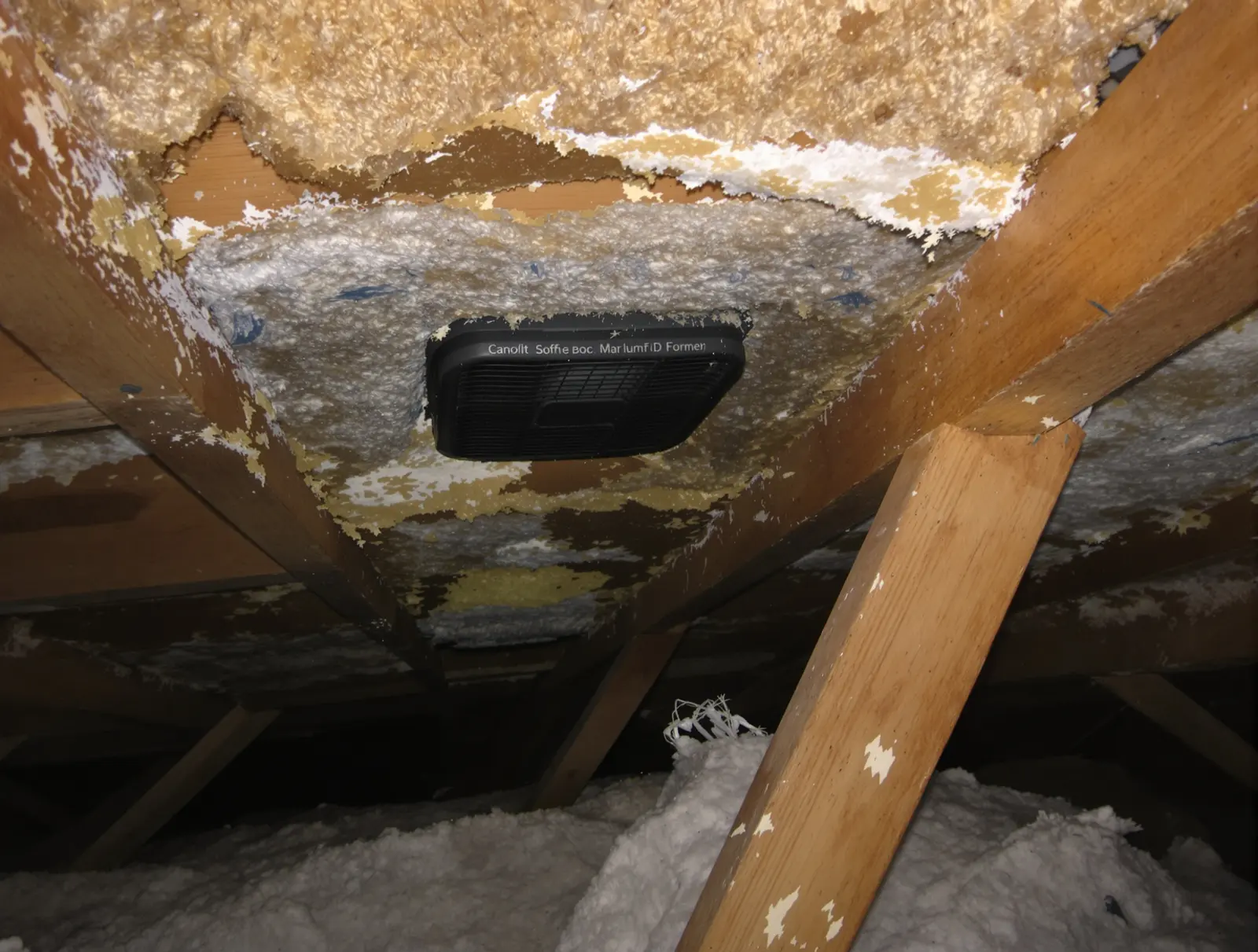 Insulation blocking soffit vent openings at the eave area inside an attic