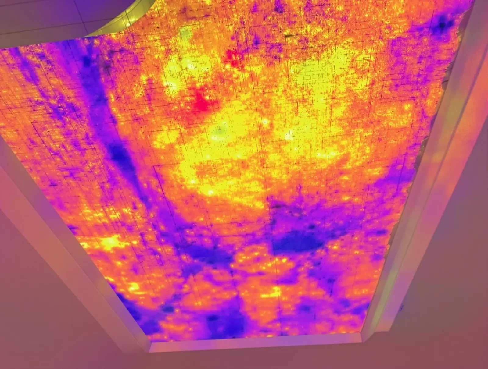 Thermal image revealing insulation gaps in a ceiling where heat is transferring from the attic