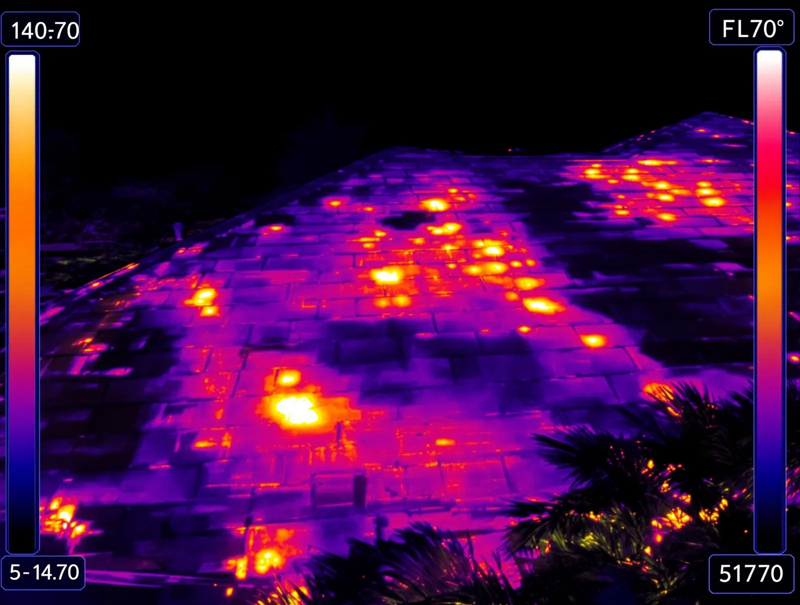 Thermal image showing the heat signature difference between dark and light roof surfaces
